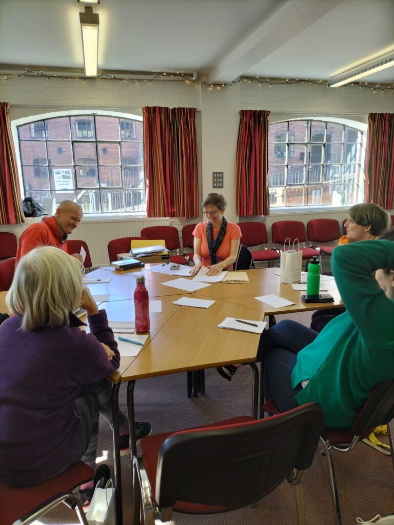 Group of people participating in a Healing Through Creative Writing session.